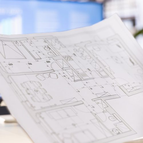Architect drawing schematics providing technical and aesthetic advice on the design of infrastructures. Close up of architecture specialist designing plans for buildings restorations and alterations